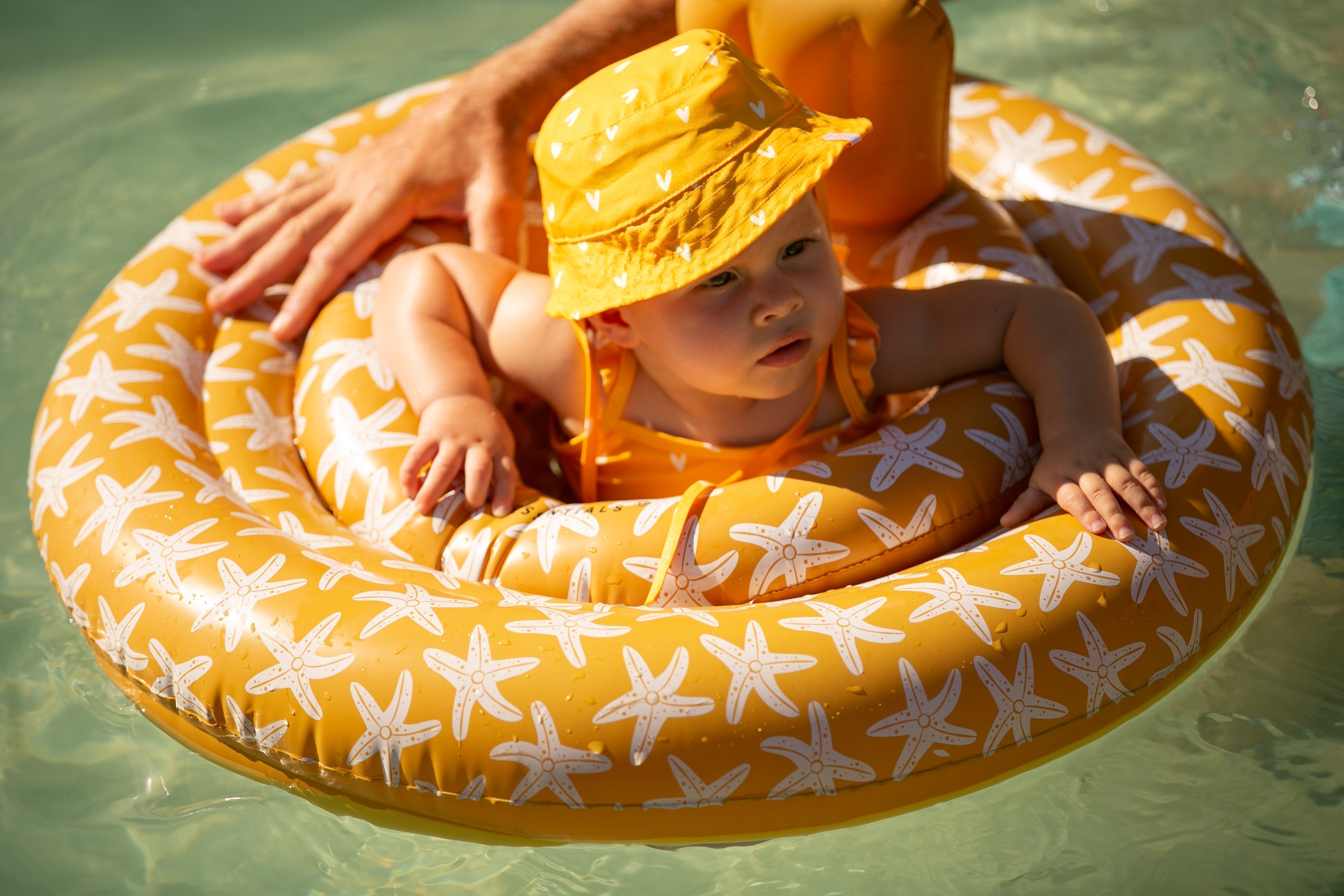 baby float with orange seastars