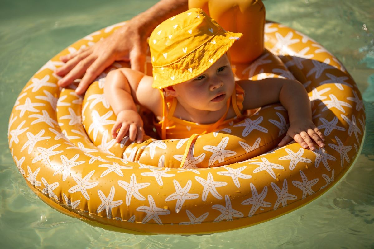 baby float with orange seastars