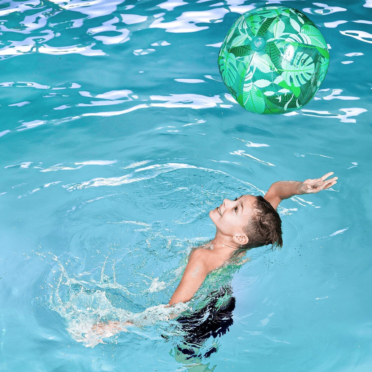kid playing with beach ball