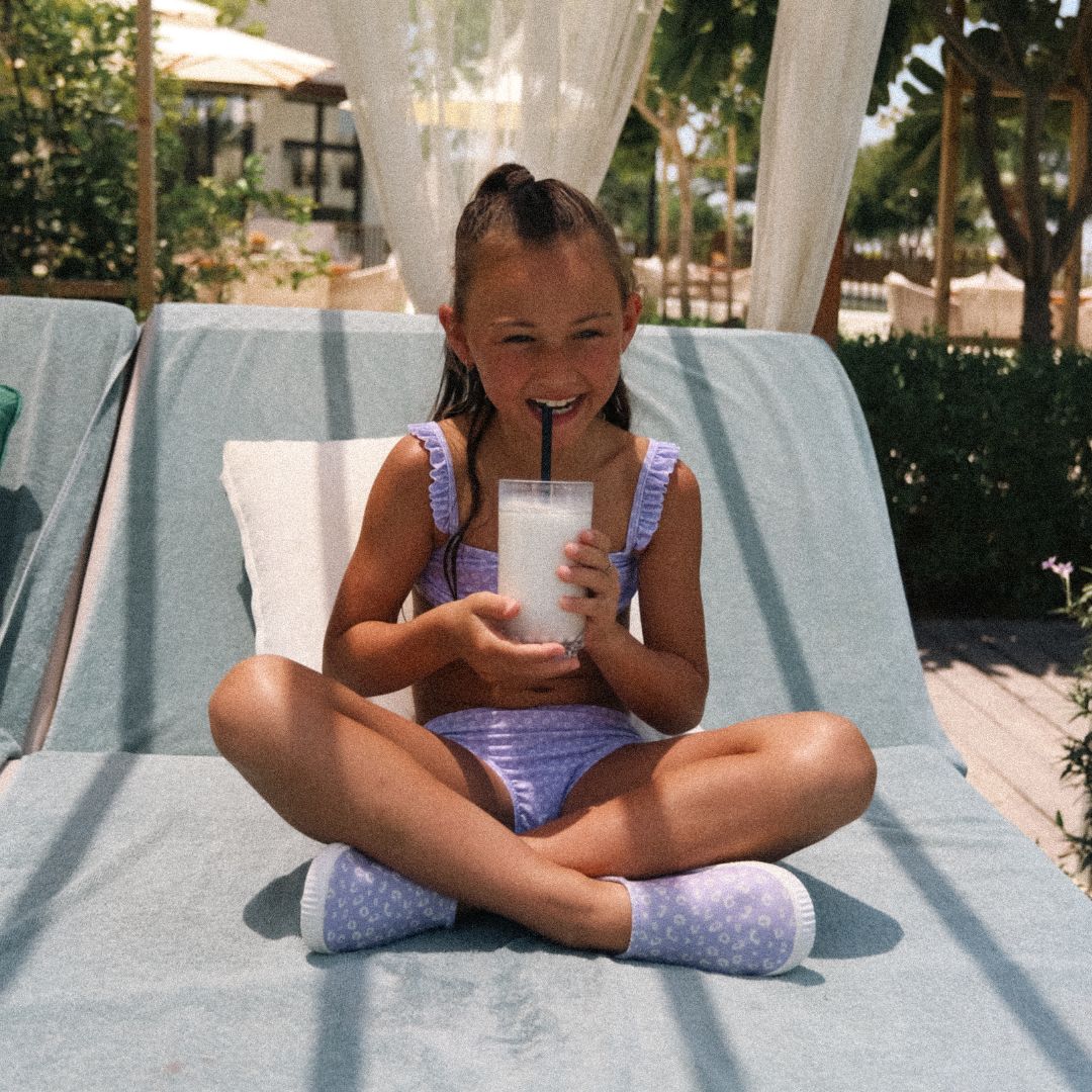 girl drinking with leopard print bikini