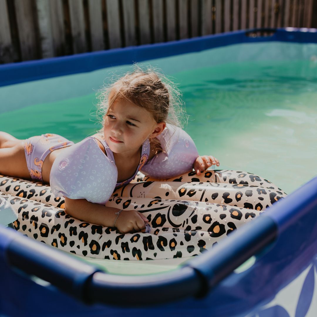 child on pool float in frame pool