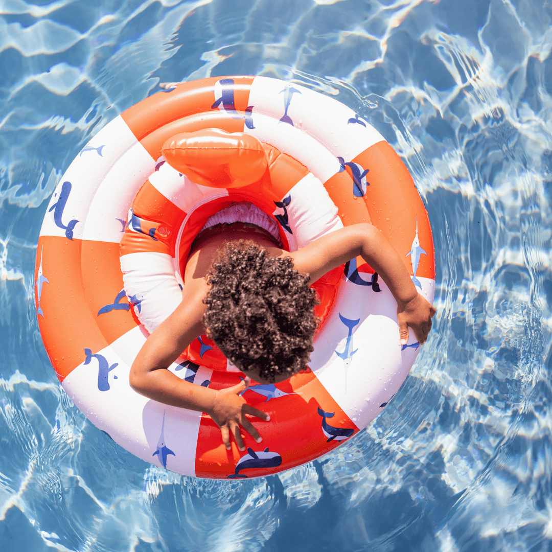 Child on an inflatable ring in a pool